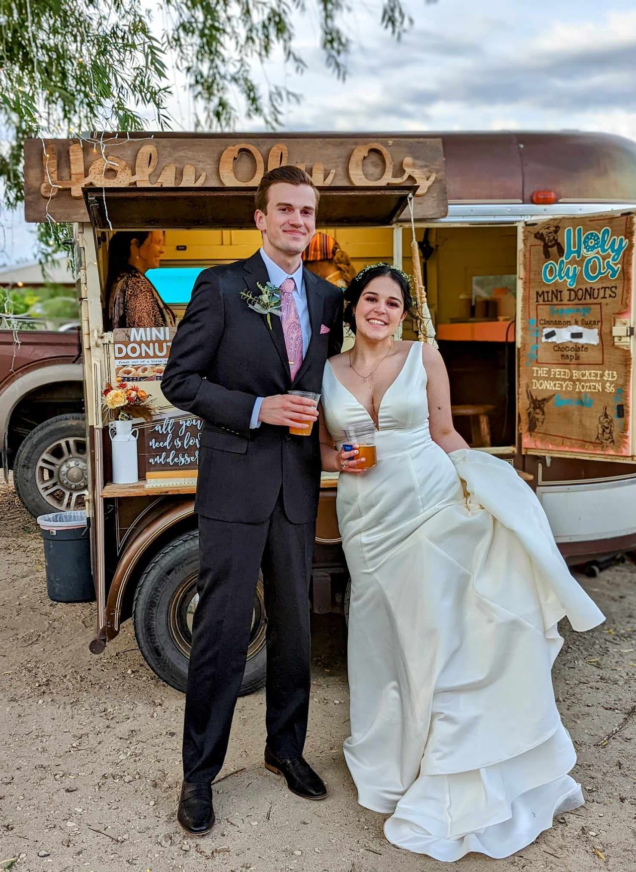 An engaged couple in front of the Holy Oly Os trailer